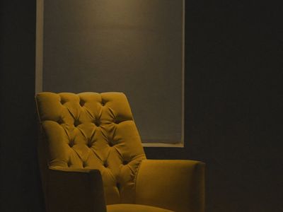 Comfortable chair in a brightly lit room for relaxation.